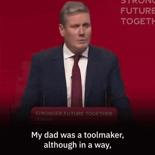 A Woman Is Sitting In A Crowd With The Words " My Dad Was A Toolmaker Although In A Way " GIF