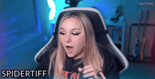 A Woman Is Sitting In A Gaming Chair And The Name Spidertiff Is On The Bottom GIF