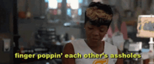 A Woman Is Sitting In A Living Room With The Words Finger Poppin ' Each Other 'S Assholes Above Her . GIF