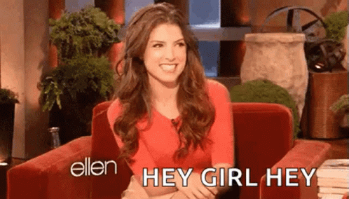 A Woman Is Sitting In A Red Chair And Smiling While Talking To Ellen Degeneres . GIF