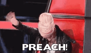 A Woman Is Sitting In A Red Chair With Her Hands In The Air And The Words `` Preach '' Written On The Screen . GIF