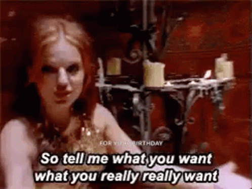 A Woman Is Sitting In A Room With Candles And Says `` So Tell Me What You Want What You Really Really Want '' GIF