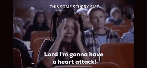 A Woman Is Sitting In A Theater Watching A Movie And Saying `` Lord I 'M Gonna Have A Heart Attack '' GIF