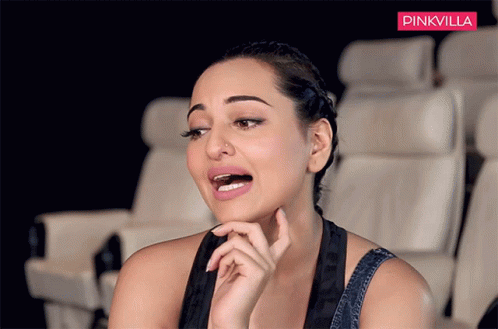 A Woman Is Sitting In A Theatre With A Pinkvilla Logo Behind Her GIF