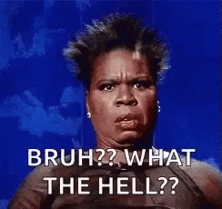 A Woman Is Sitting In Front Of A Blue Background And Making A Funny Face . GIF