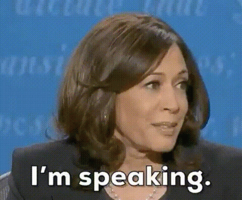 A Woman Is Sitting In Front Of A Blue Background And Saying `` I 'M Speaking . '' GIF