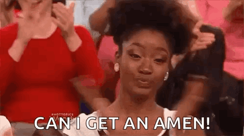 A Woman Is Sitting In Front Of A Crowd Of People And Making A Face . GIF