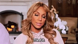 A Woman Is Sitting In Front Of A Fireplace With Her Eyes Closed And Saying `` I Tried It '' . GIF