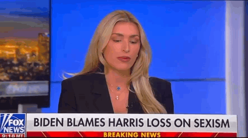 A Woman Is Sitting In Front Of A Fox News Breaking News Sign . GIF