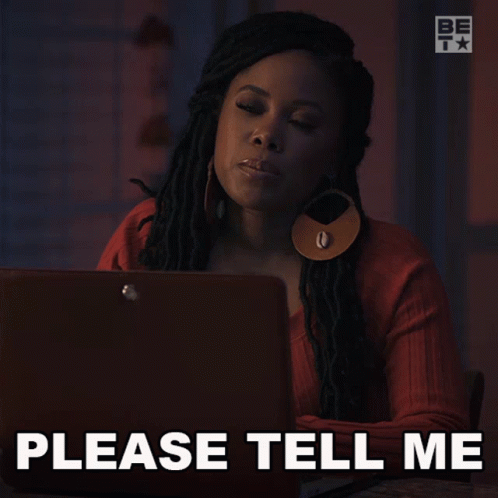 a woman is sitting in front of a laptop with the words please tell me below her