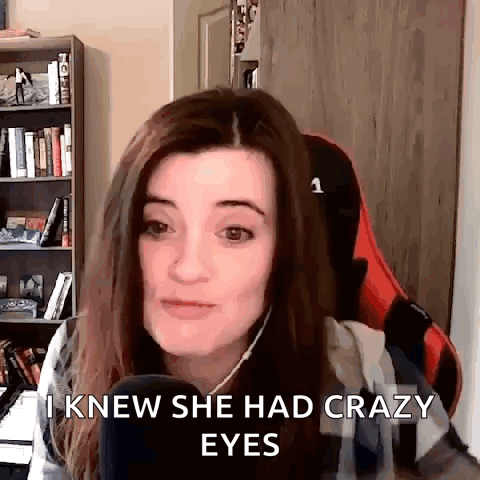 A Woman Is Sitting In Front Of A Microphone And Saying `` I Knew She Had Crazy Eyes '' GIF