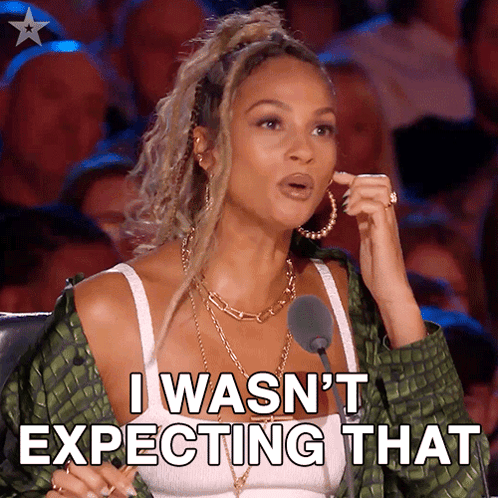 A Woman Is Sitting In Front Of A Microphone And Says I Wasn 'T Expecting That GIF