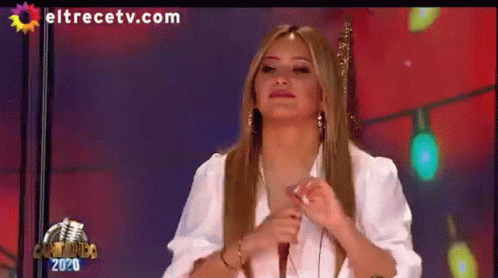 A Woman Is Sitting In Front Of A Microphone On A Television Screen With Eltrecetv.com Written On It GIF