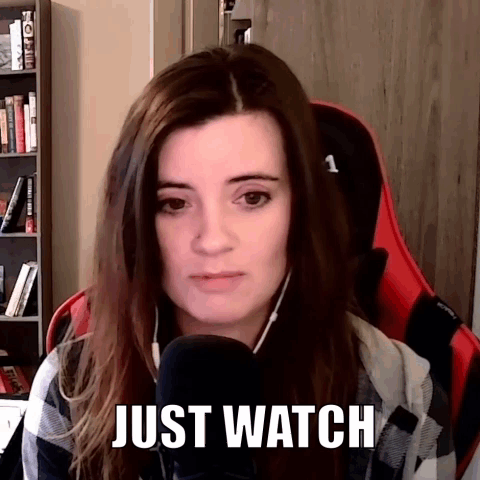 A Woman Is Sitting In Front Of A Microphone With The Words Just Watch Above Her Head . GIF
