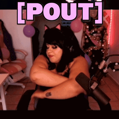 A Woman Is Sitting In Front Of A Microphone With The Words [ Pout ] Written Above Her GIF