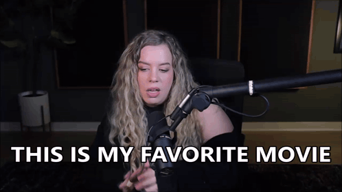 A Woman Is Sitting In Front Of A Microphone With The Words `` This Is My Favorite Movie '' Written Above Her . GIF