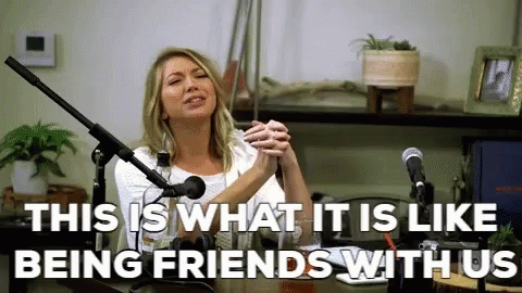 A Woman Is Sitting In Front Of A Microphone With The Words " This Is What It Is Like Being Friends With Us " GIF