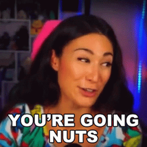 A Woman Is Sitting In Front Of A Microphone With The Words `` You 'Re Going Nuts '' Written On Her Face . GIF