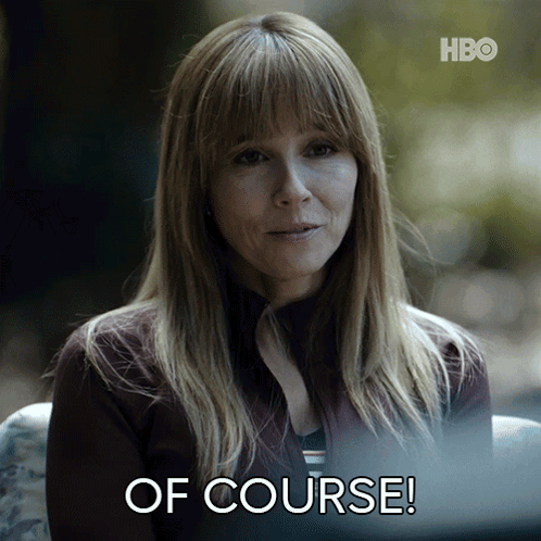 a woman is sitting in front of a screen that says of course
