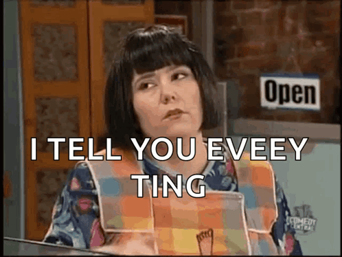 A Woman Is Sitting In Front Of A Sign That Says Open GIF