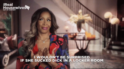 A Woman Is Sitting In Front Of A Sign That Says ' Real Housewives ' On It GIF