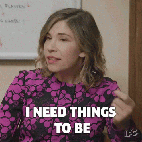 A Woman Is Sitting In Front Of A White Board And Says `` I Need Things To Be '' . GIF