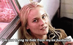 A Woman Is Sitting In Front Of A Window Holding A Cell Phone And Saying I 'M Just Trying To Hide GIF