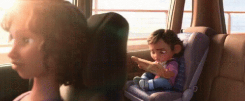 A Woman Is Sitting In The Back Seat Of A Car With A Baby In A Car Seat . GIF