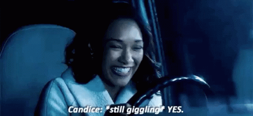 A Woman Is Sitting In The Driver 'S Seat Of A Car . GIF