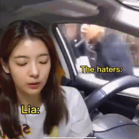 A Woman Is Sitting In The Driver 'S Seat Of A Car While A Man Is Smoking A Cigarette . GIF