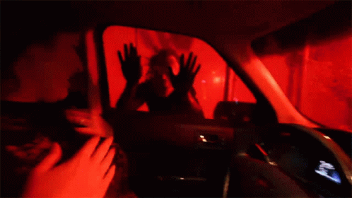 A Woman Is Sitting In The Driver 'S Seat Of A Ford Car . GIF