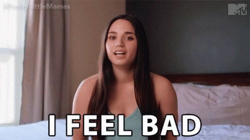 A Woman Is Sitting On A Bed And Saying " I Feel Bad " GIF