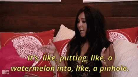 A Woman Is Sitting On A Bed And Saying It 'S Like Putting Like A Watermelon Into Like A Pinhole .. GIF