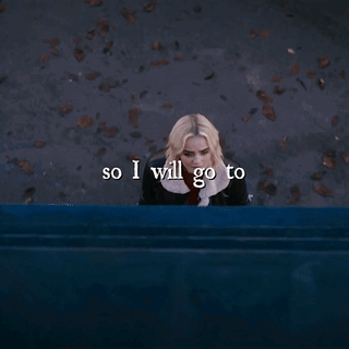 A Woman Is Sitting On A Blue Bench With The Words So I Will Go To Written Below Her GIF