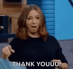 A Woman Is Sitting On A Couch And Giving A Thank You Gesture . GIF