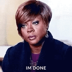 A Woman Is Sitting On A Couch And Making A Funny Face And Saying `` Im Done '' . GIF