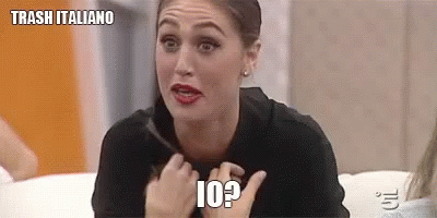 A Woman Is Sitting On A Couch And Making A Funny Face While Holding Her Hair . GIF