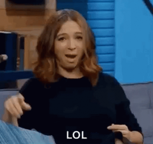 Woman Sitting On Couch Making Funny Face Pointing GIF