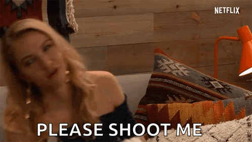 A Woman Is Sitting On A Couch And Saying Please Shoot Me GIF