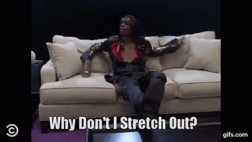 A Woman Is Sitting On A Couch And Saying Why Don 'T I Stretch Out GIF