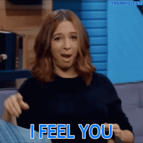 A Woman Is Sitting On A Couch And Says " I Feel You " GIF