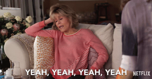 A Woman Is Sitting On A Couch And Says Yeah Yeah Yeah GIF