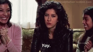 A Woman Is Sitting On A Couch Talking To Two Other Women . GIF