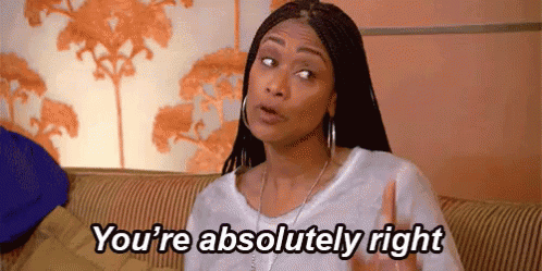 A Woman Is Sitting On A Couch With Her Hand Up And Says `` You 'Re Absolutely Right '' . GIF