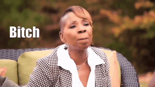 A Woman Is Sitting On A Couch With The Word Bitch Written In The Background GIF