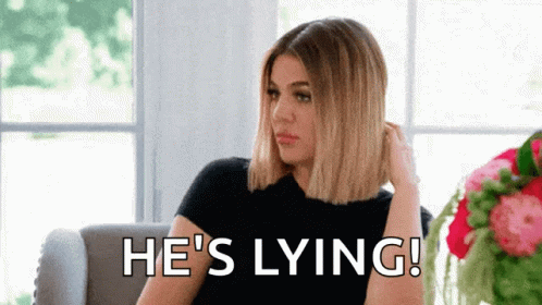 A Woman Is Sitting On A Couch With The Words `` He 'S Lying '' Written On The Screen . GIF