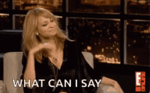 A Woman Is Sitting On A Couch With The Words What Can I Say Behind Her GIF