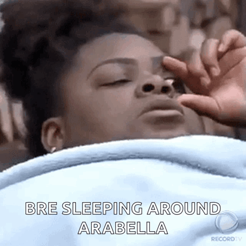 A Woman Is Sleeping In Bed With Her Eyes Closed And Her Hand On Her Face . GIF