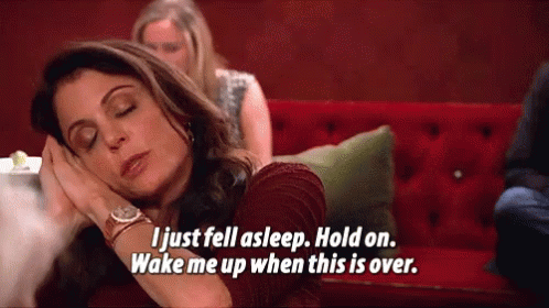 a woman is sleeping on a red couch and saying " i just fell asleep hold on wake me up when this is over