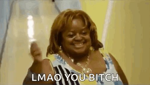A Woman Is Smiling And Giving A Thumbs Up With The Words `` Lmao You Bitch '' Written Below Her . GIF